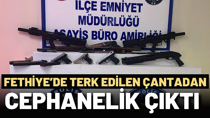 Fethiye’de bir iş yeri önüne bırakılan şüpheli çantayı inceleyen polis